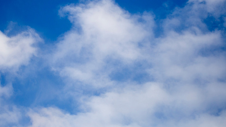 Blue sky with wispy white clouds